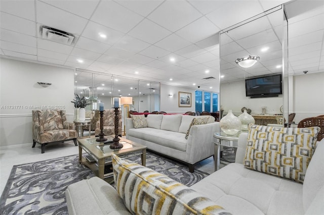 living room featuring a drop ceiling