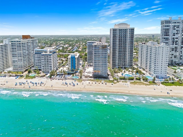 birds eye view of property with a view of the beach and a water view