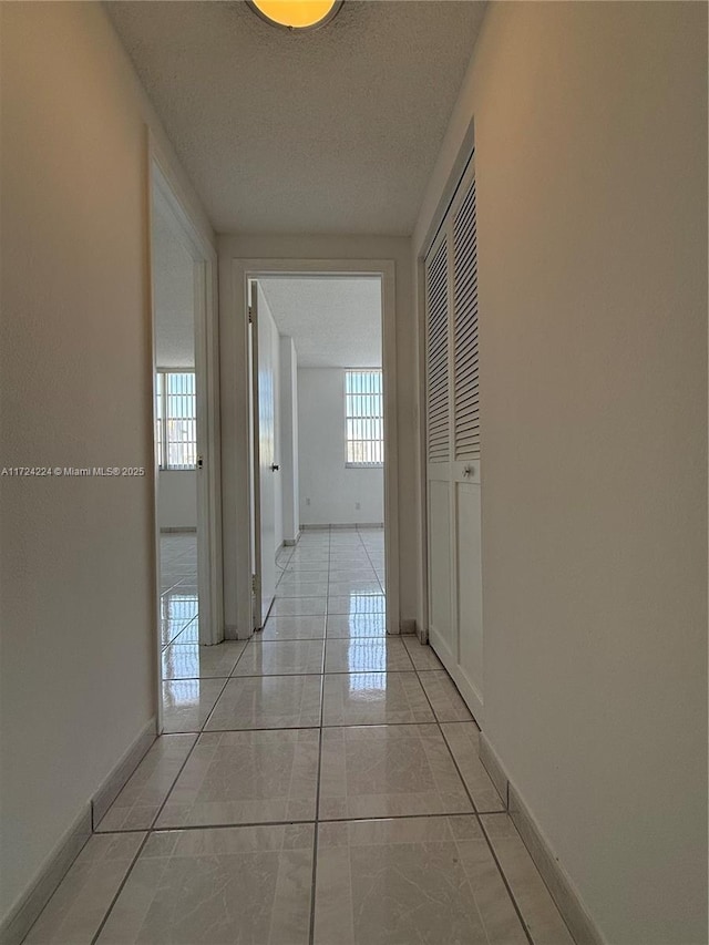 hallway featuring light tile patterned floors