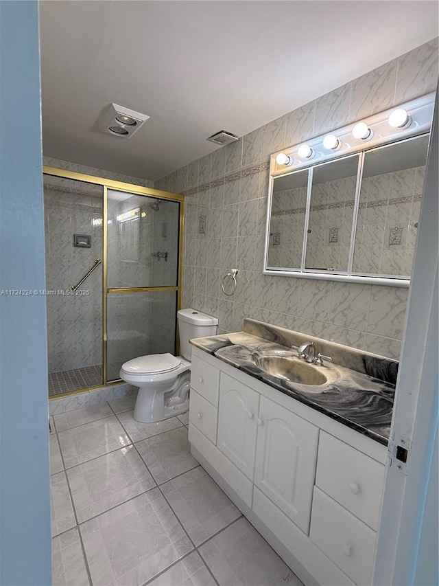 bathroom featuring vanity, tile walls, walk in shower, and toilet