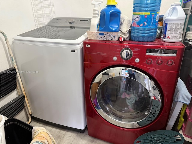 washroom featuring light hardwood / wood-style floors and washer and dryer