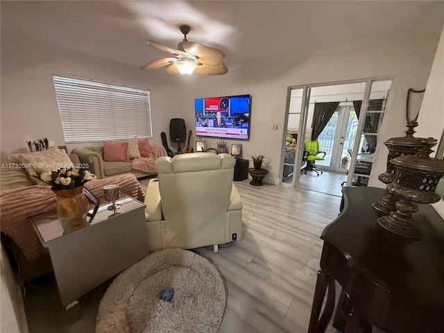 living room featuring ceiling fan, light wood-type flooring, and french doors