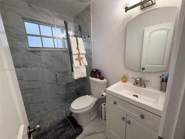 bathroom with vanity, an enclosed shower, and toilet