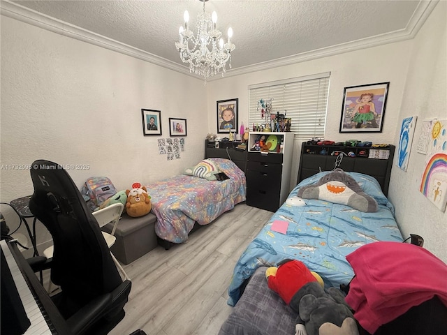 bedroom with an inviting chandelier, crown molding, light hardwood / wood-style floors, and a textured ceiling