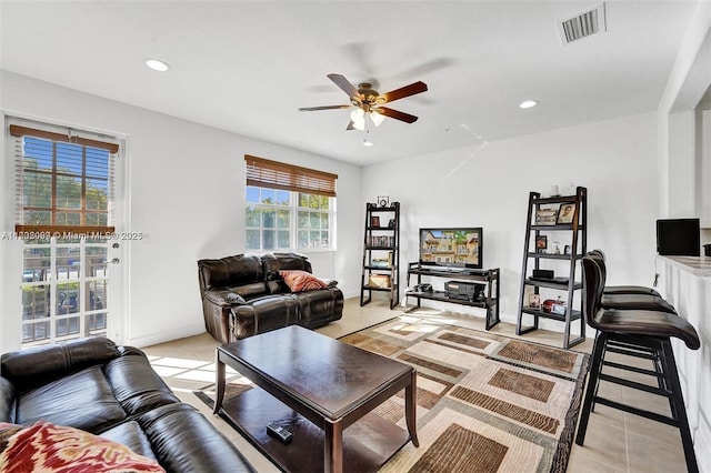 living room featuring light tile patterned flooring and ceiling fan