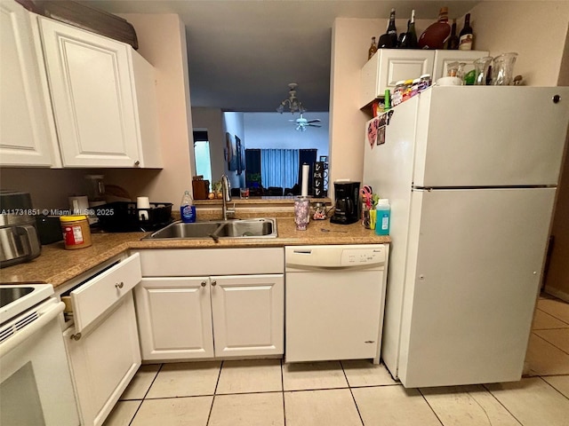 kitchen with white cabinetry, sink, white appliances, and light tile patterned flooring