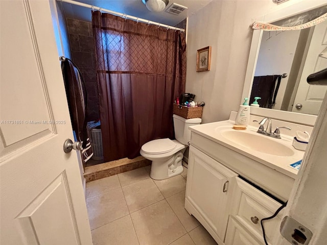 bathroom with walk in shower, vanity, toilet, and tile patterned flooring