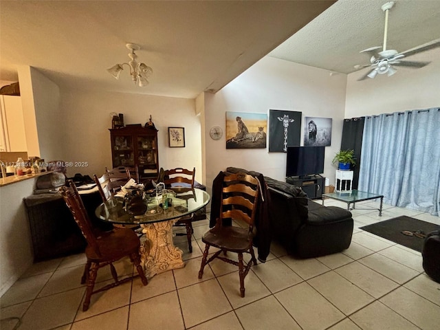 dining room with light tile patterned floors, a textured ceiling, and ceiling fan