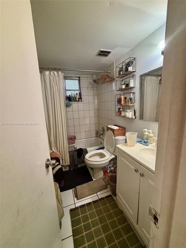 full bathroom with tile patterned floors, toilet, shower / bath combo with shower curtain, and vanity