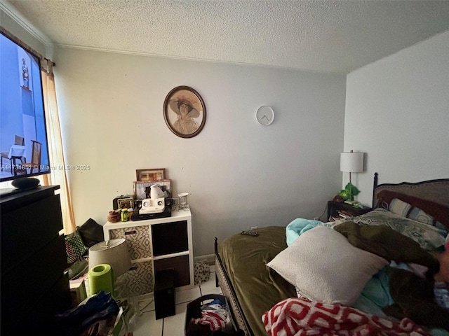 bedroom with tile patterned floors and a textured ceiling