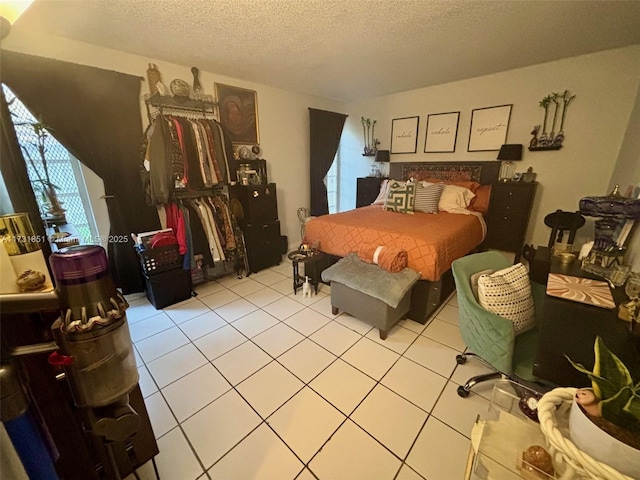 tiled bedroom featuring a textured ceiling