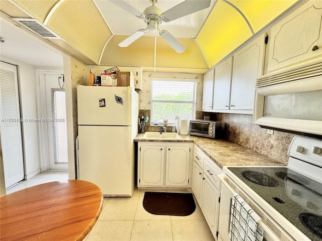 kitchen with sink, white appliances, light tile patterned floors, backsplash, and vaulted ceiling