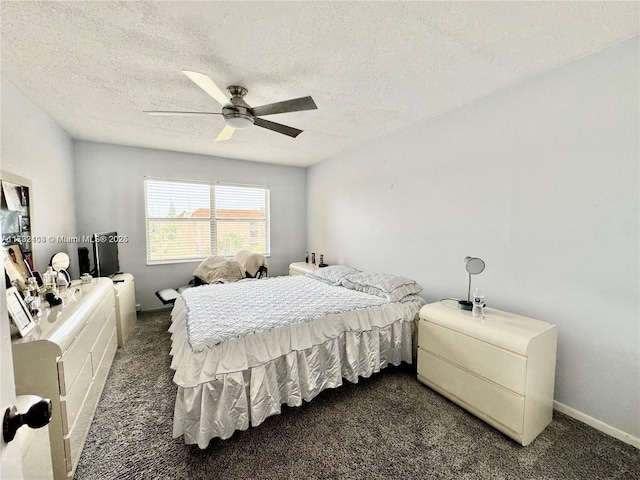 bedroom with a textured ceiling, ceiling fan, and dark colored carpet