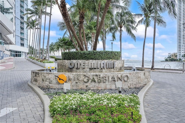 community / neighborhood sign featuring a water view