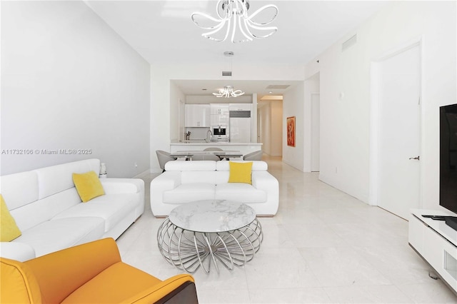 living room featuring an inviting chandelier and sink