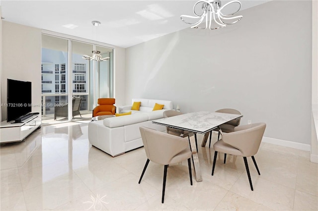 dining space featuring a notable chandelier and a wall of windows