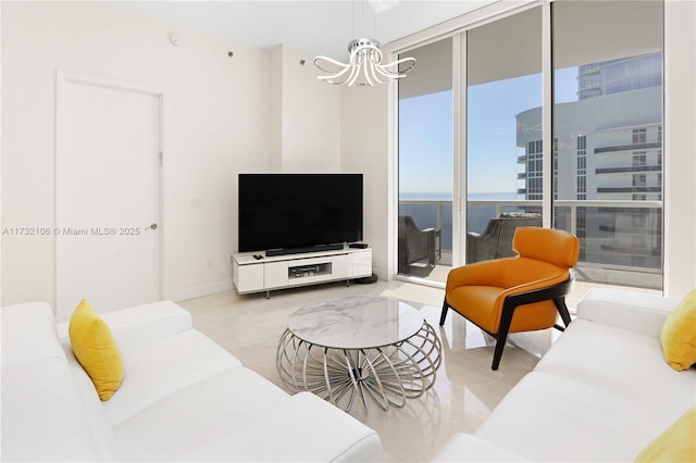 living room featuring a wall of windows and a chandelier