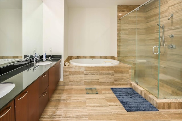 bathroom with vanity and independent shower and bath