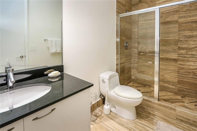 bathroom featuring vanity, walk in shower, and toilet