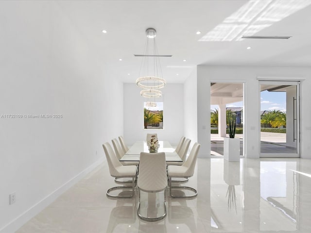 dining room featuring light tile patterned floors and a chandelier