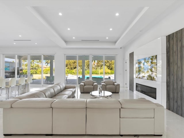 living room featuring french doors and a tray ceiling