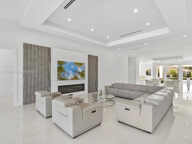 living room featuring a raised ceiling