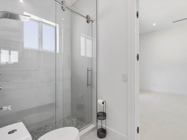 bathroom with an enclosed shower, tile patterned flooring, and toilet