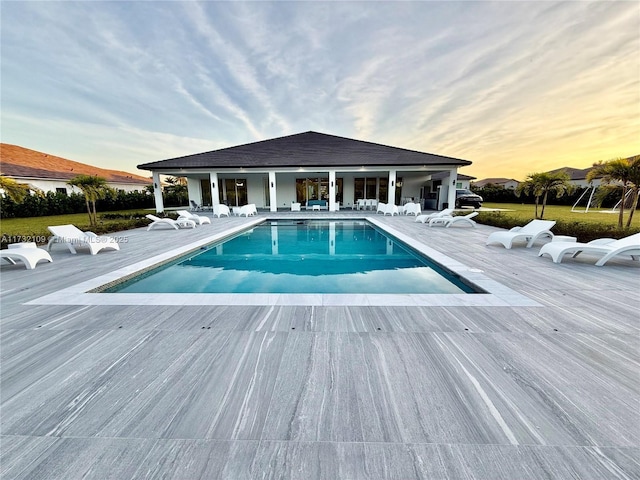 view of pool at dusk