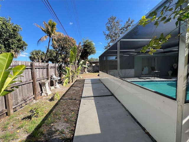 view of pool featuring a patio and glass enclosure