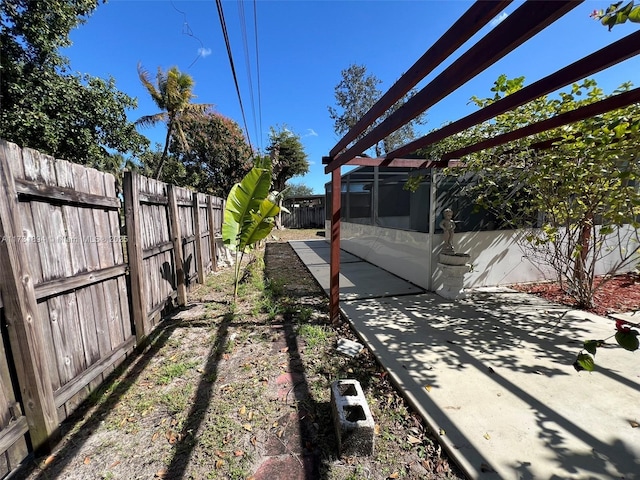 view of yard with a pergola and a patio