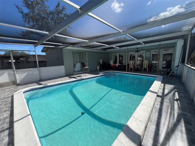 view of swimming pool with a lanai, ceiling fan, and a patio area