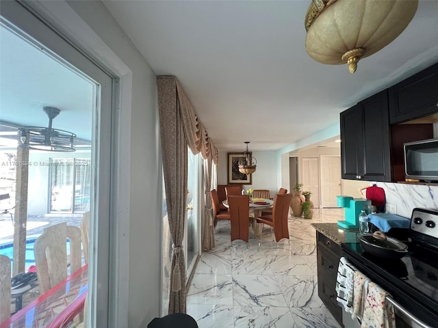 interior space featuring hanging light fixtures and stainless steel electric stove