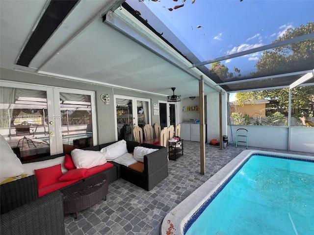 view of pool featuring a lanai, a patio area, and french doors