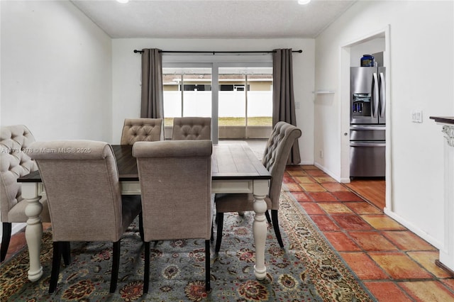 dining room featuring a textured ceiling