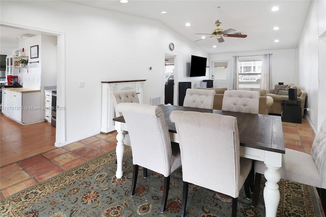 dining room with ceiling fan and lofted ceiling