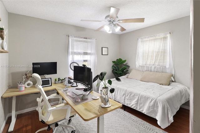 bedroom featuring wood-type flooring, ceiling fan, and a textured ceiling