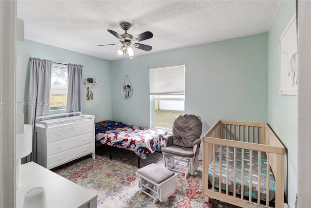 bedroom featuring a textured ceiling and ceiling fan