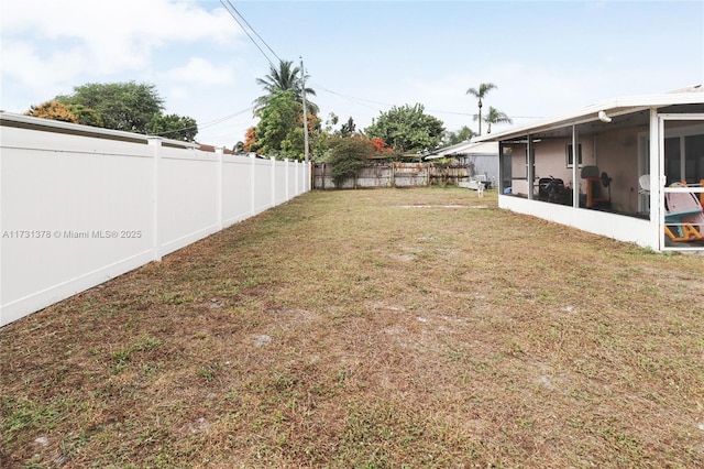 view of yard featuring a sunroom