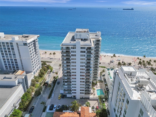 aerial view with a water view and a beach view