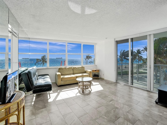 sunroom / solarium with a water view