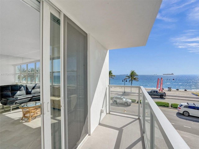 balcony with a water view and a beach view