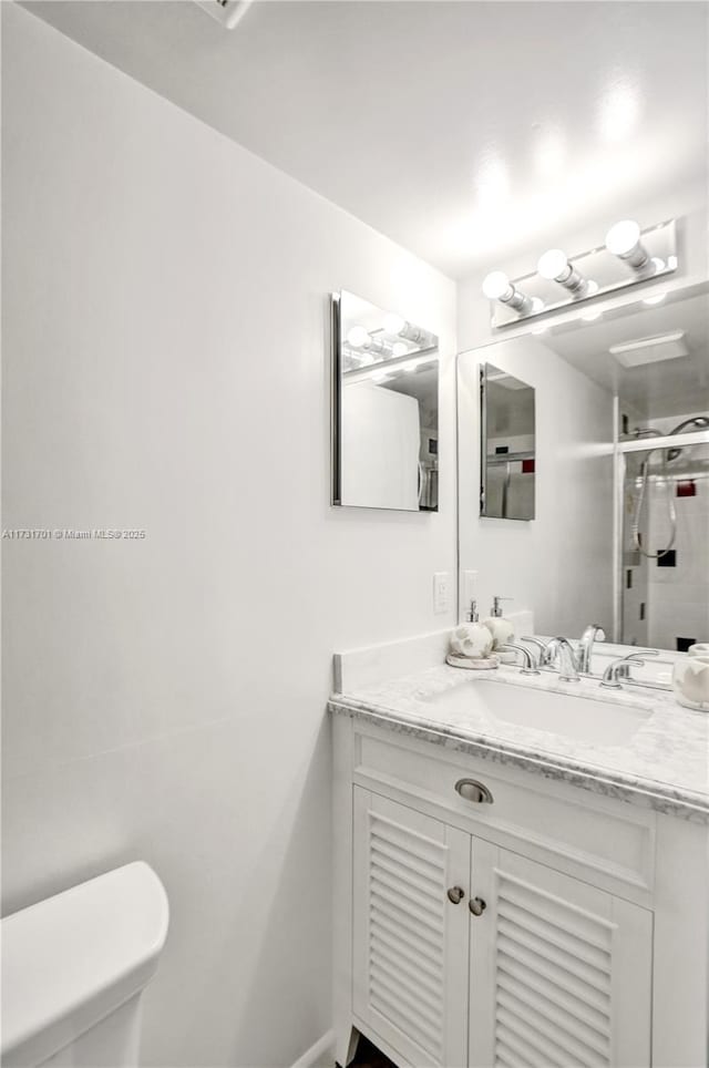 bathroom featuring vanity and toilet