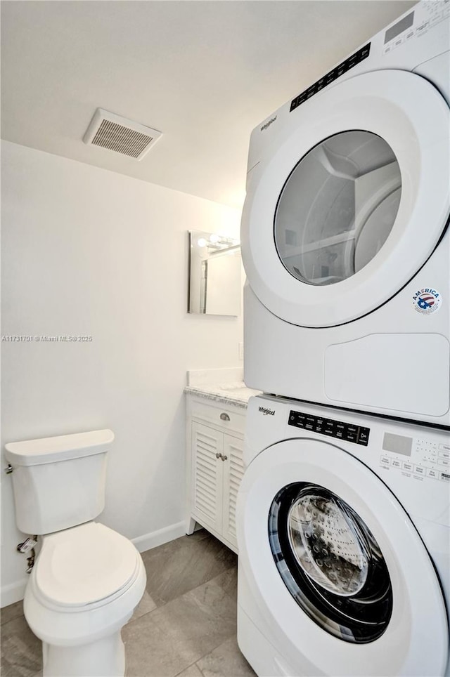 washroom featuring stacked washer and dryer