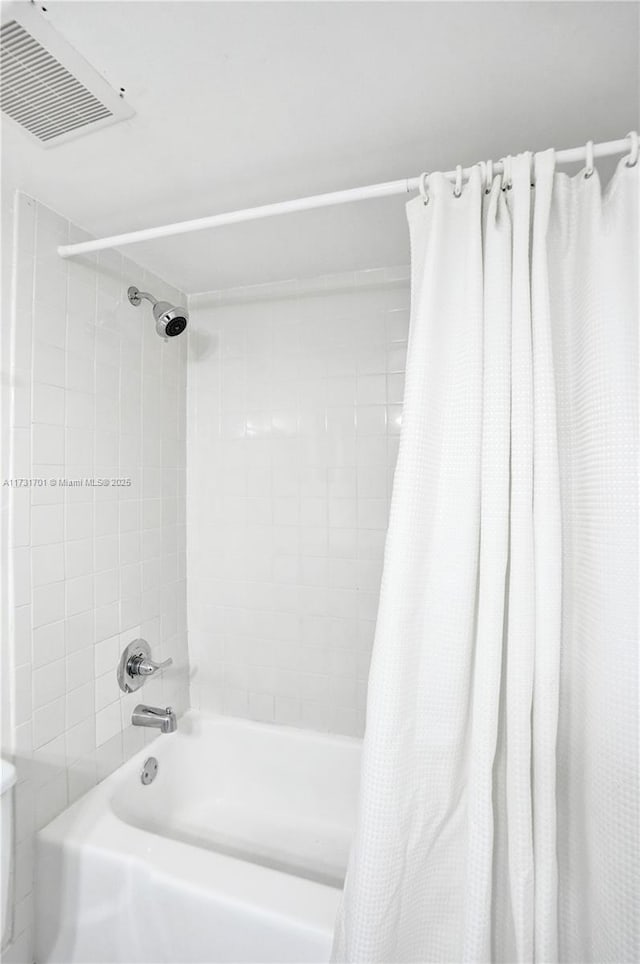 bathroom featuring shower / bath combination with curtain