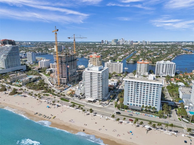 birds eye view of property with a beach view and a water view