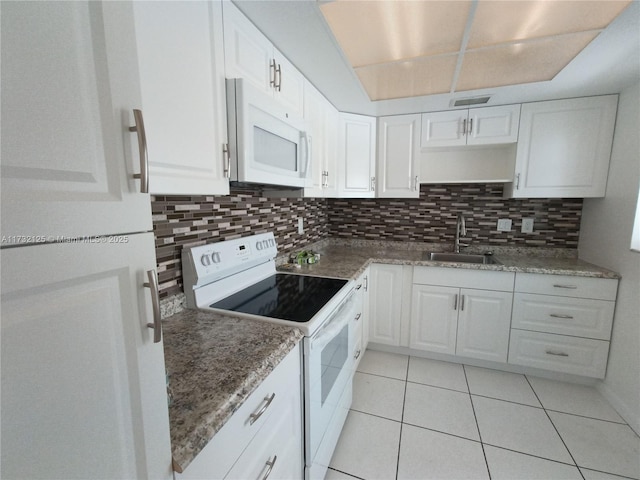 kitchen with sink, white appliances, tasteful backsplash, white cabinets, and light tile patterned flooring