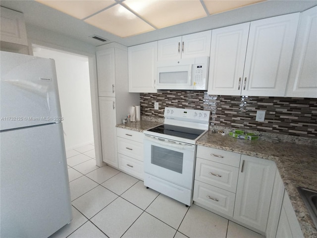 kitchen featuring light tile patterned floors, white appliances, sink, white cabinetry, and tasteful backsplash