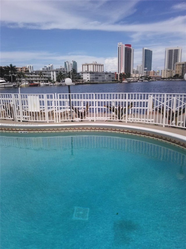 view of swimming pool featuring a water view