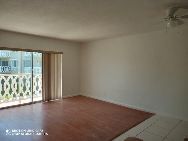 spare room with tile patterned floors and ceiling fan