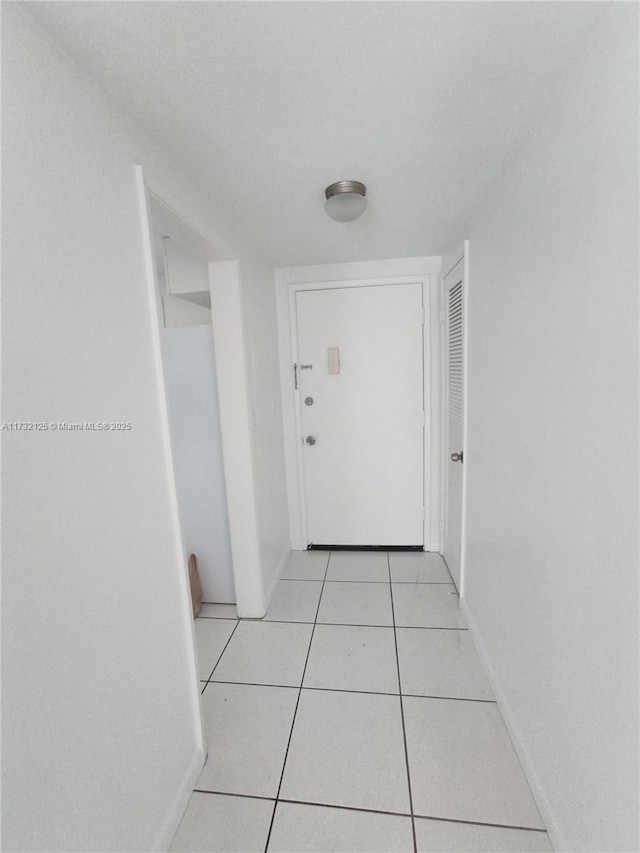 corridor with light tile patterned floors